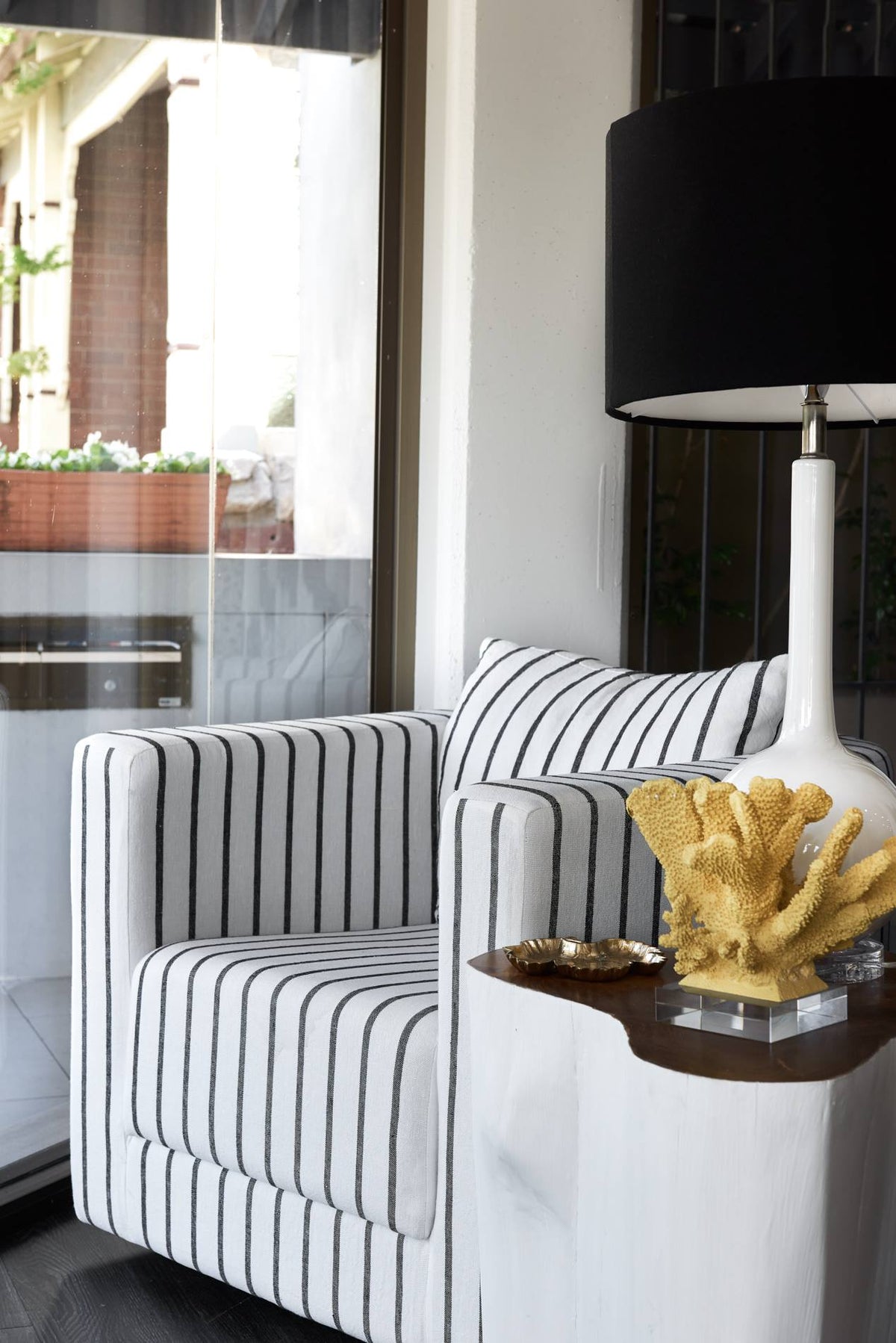 Striped upholstered armchair beside a dark table