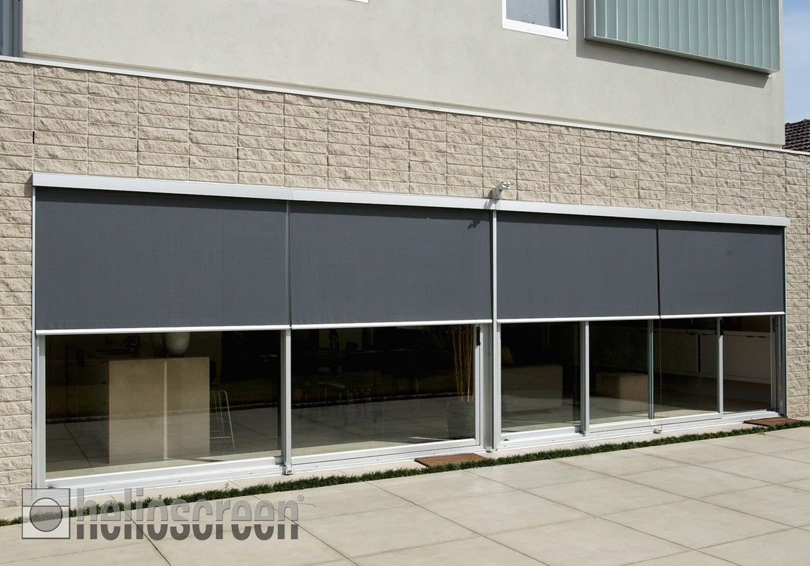 Helioscreen products: grey external roller screens shading wide glazed doors.