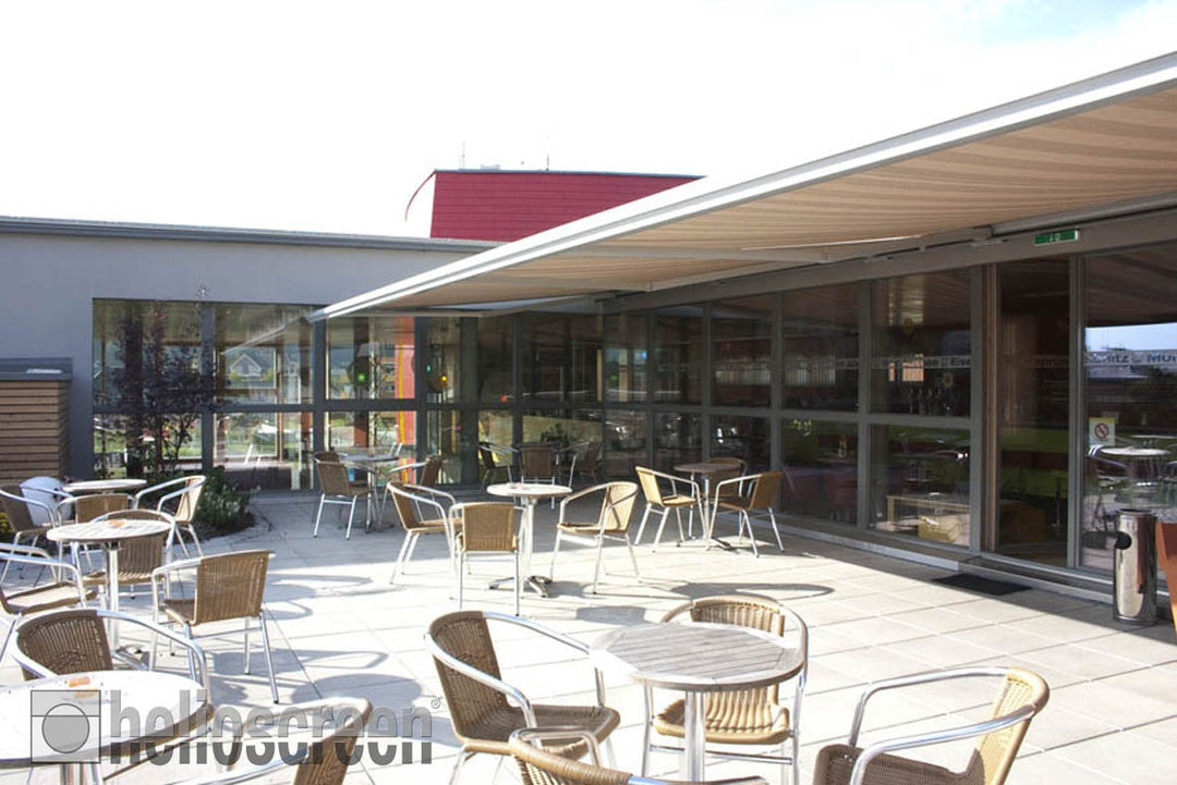 Helioscreen products: a retractable awning shading an outdoor cafe terrace.