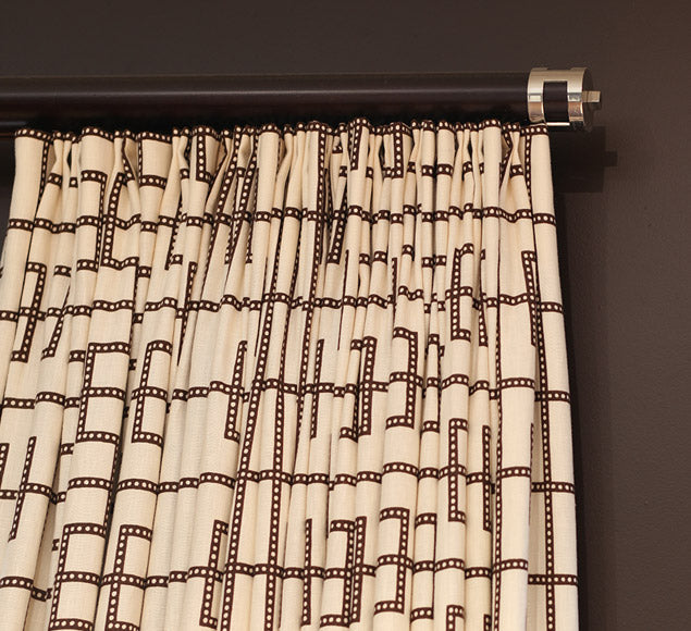 Close view of patterned curtains and their heading