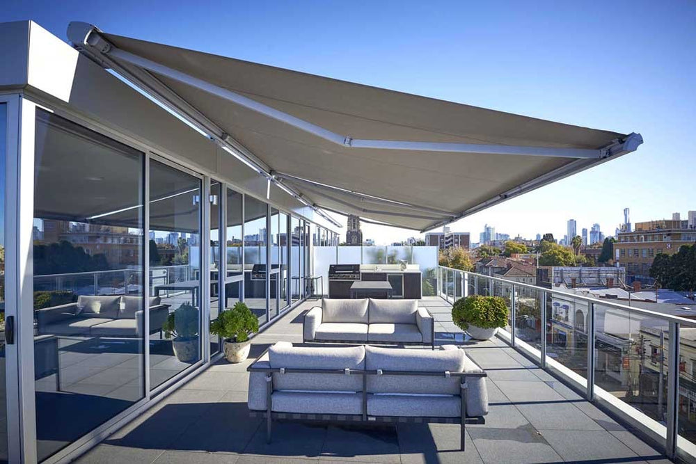 Helioscreen retractable awning shading a furnished city terrace
