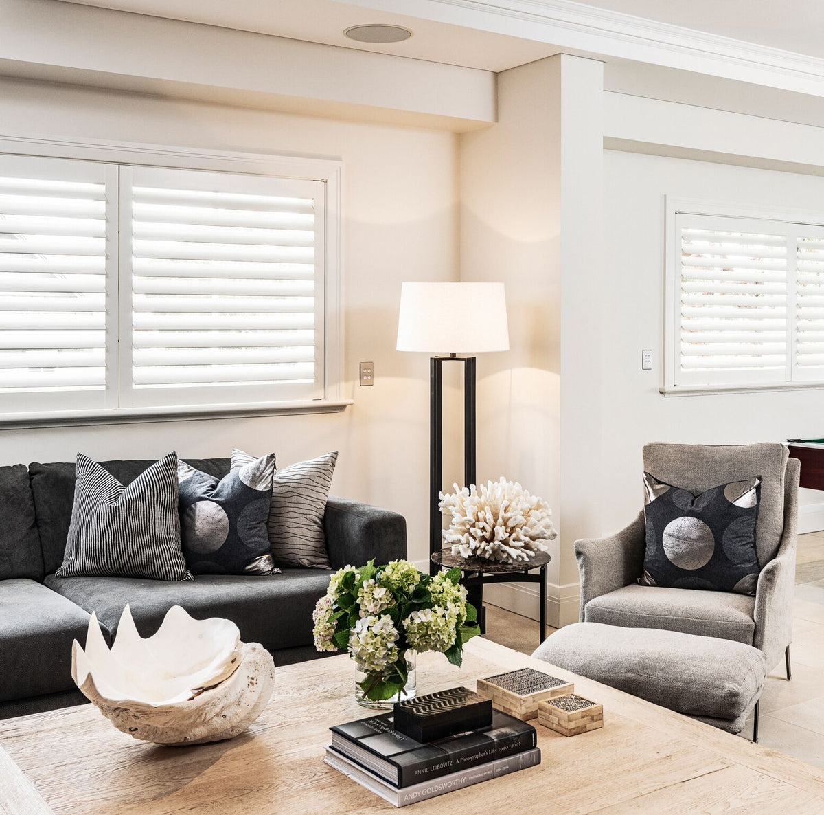 Living room seating with cushions and a glass-topped table