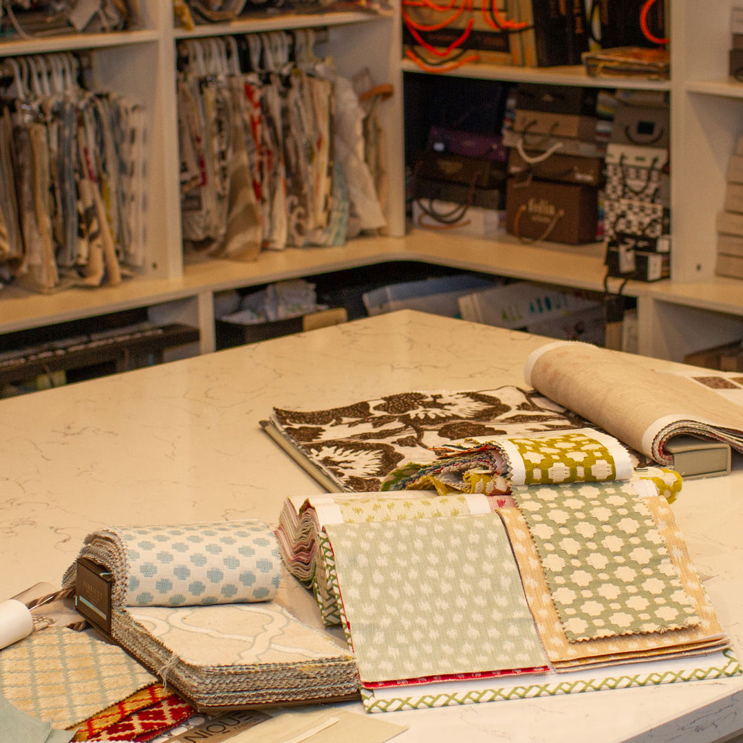 Patterned fabrics and sample books arranged on a worktable