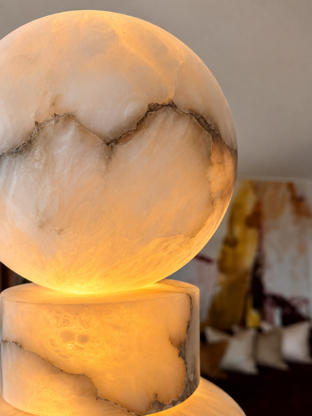 Detail of the glowing rounded top of a lamp with dark veining