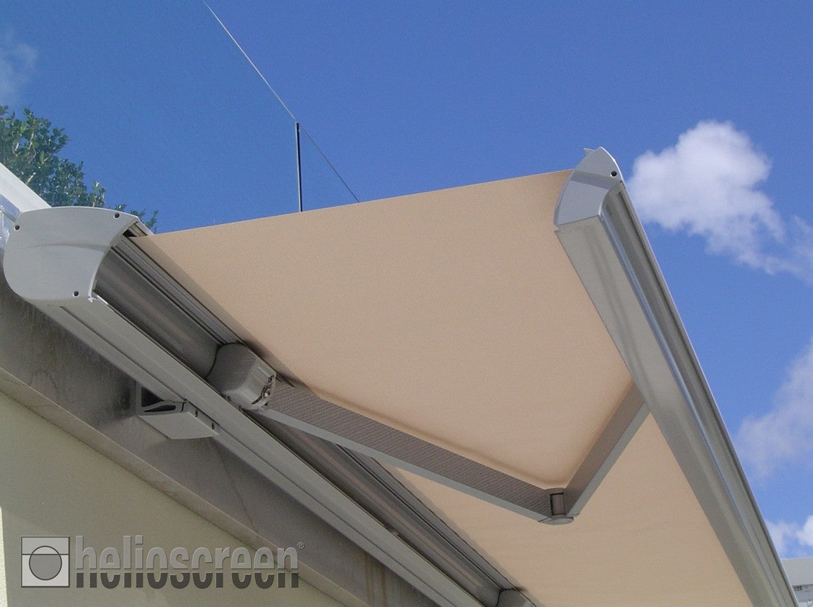 Helioscreen products: the fabric canopy and arms of a retractable awning viewed from below.
