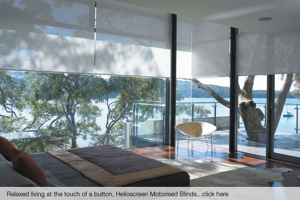 Helioscreen motorised roller blinds across floor-to-ceiling windows