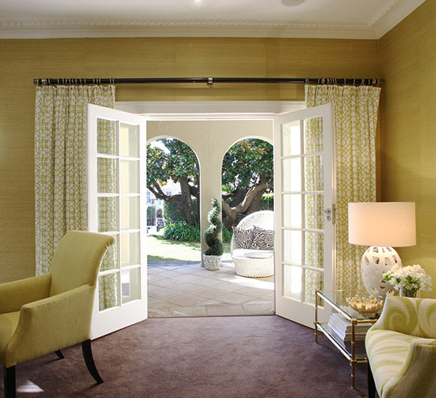 Light sitting room opening through French doors to a garden