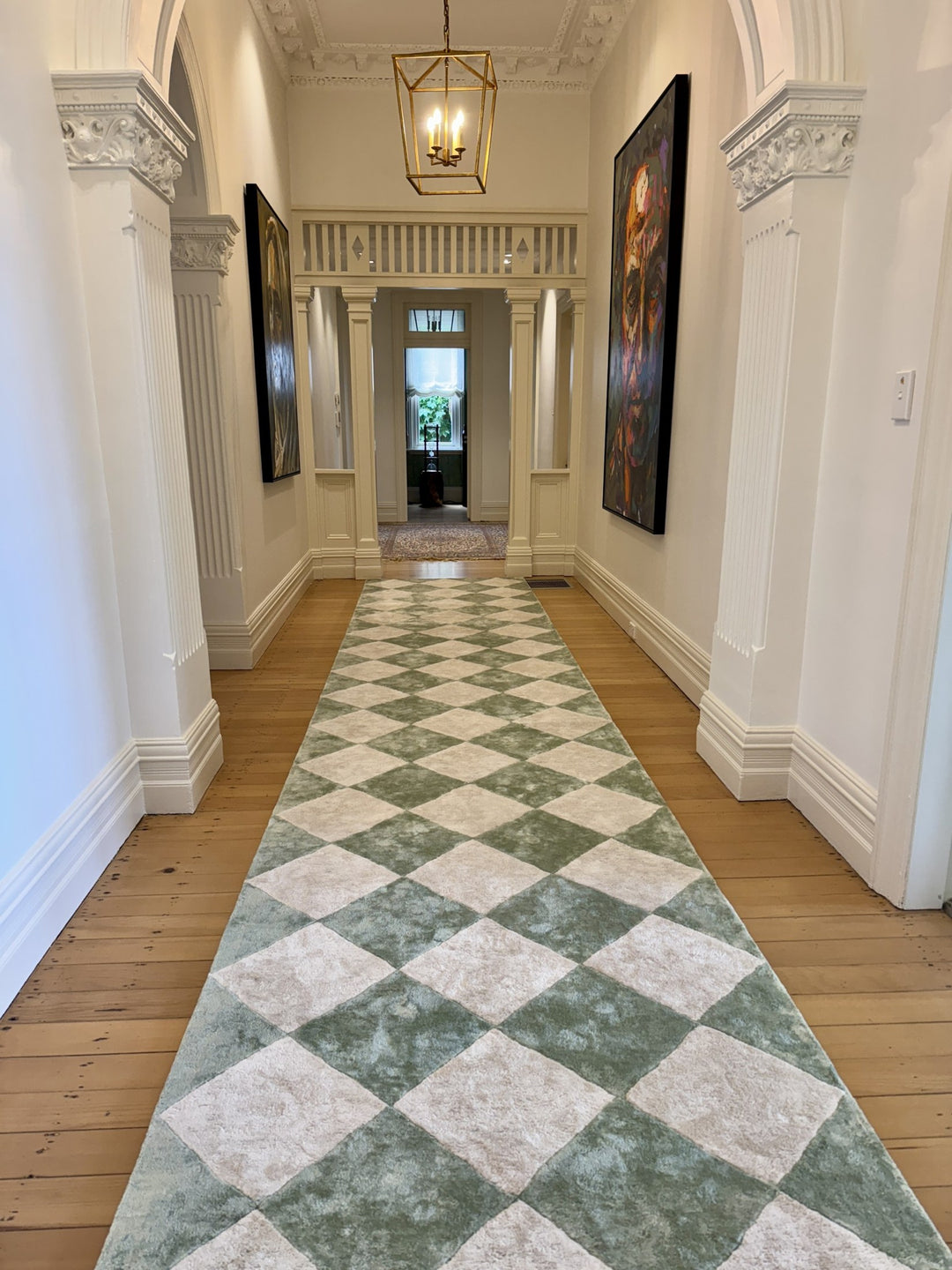 White panelled hallway with green and cream chequered flooring