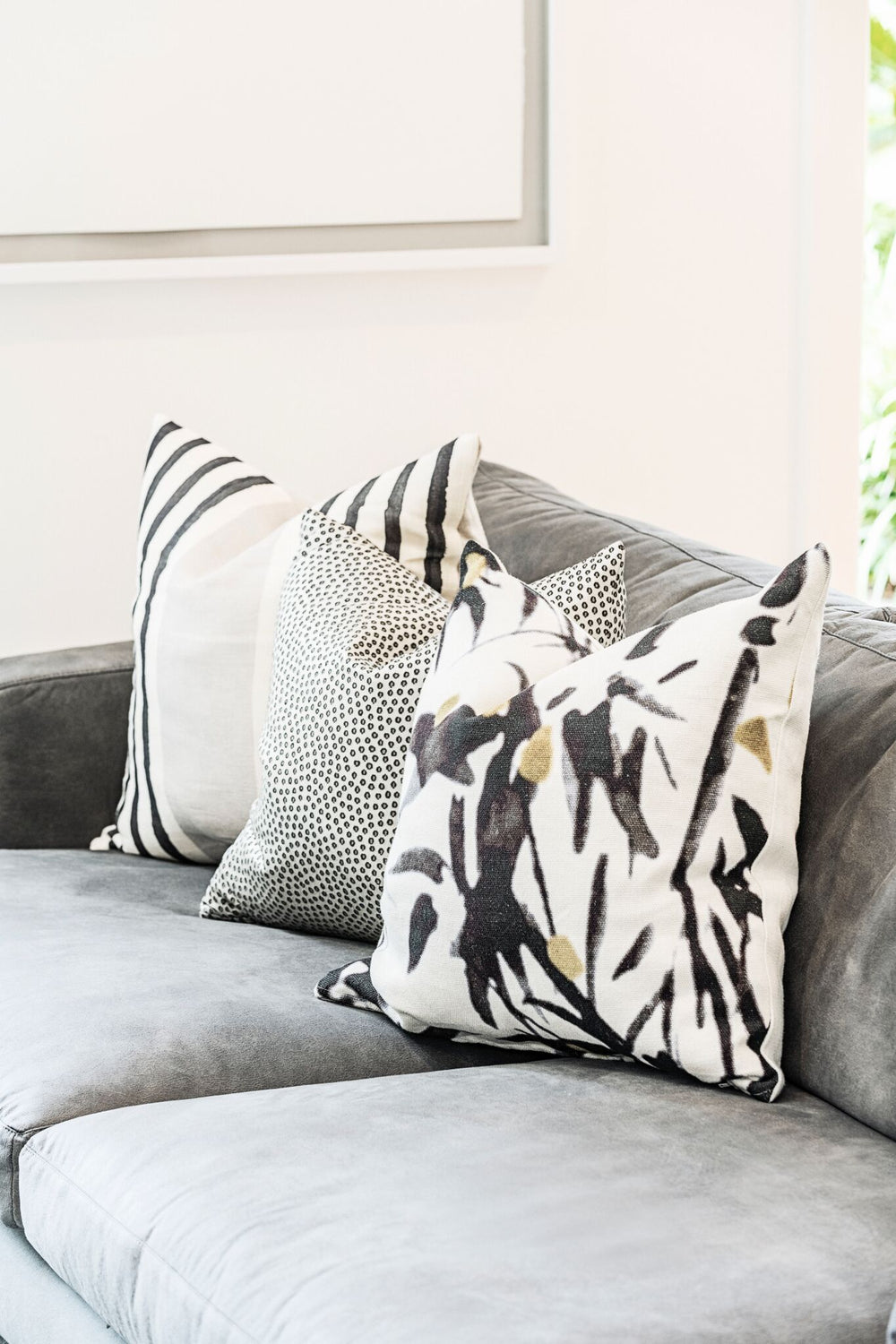 Patterned scatter cushions on a grey upholstered sofa